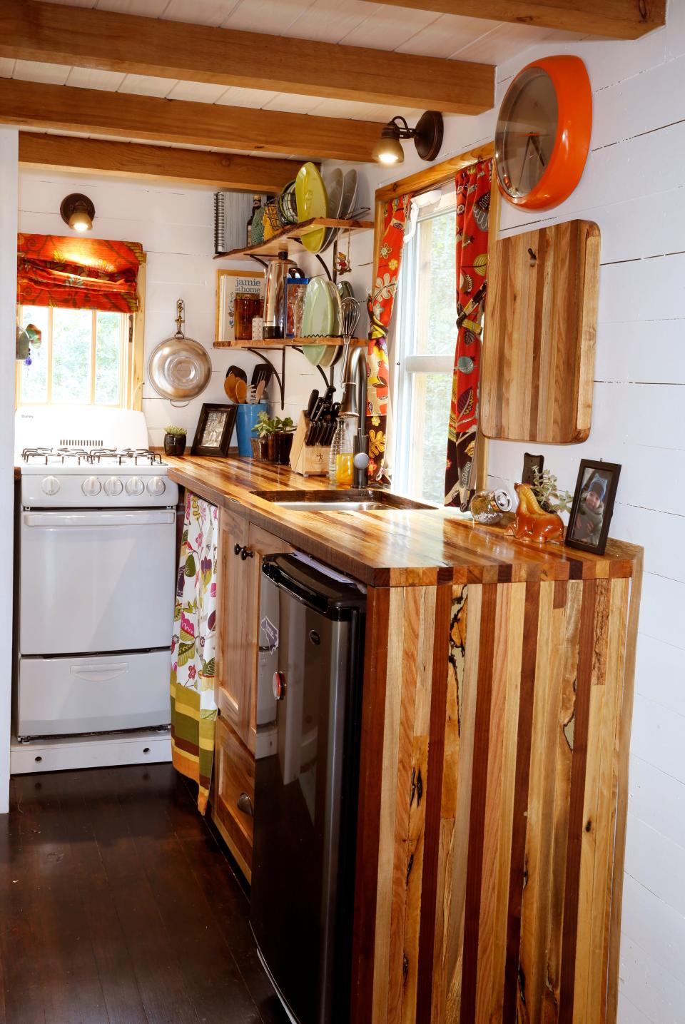 The kitchen with wood cabinetry inside Alexis Stephen's tiny house