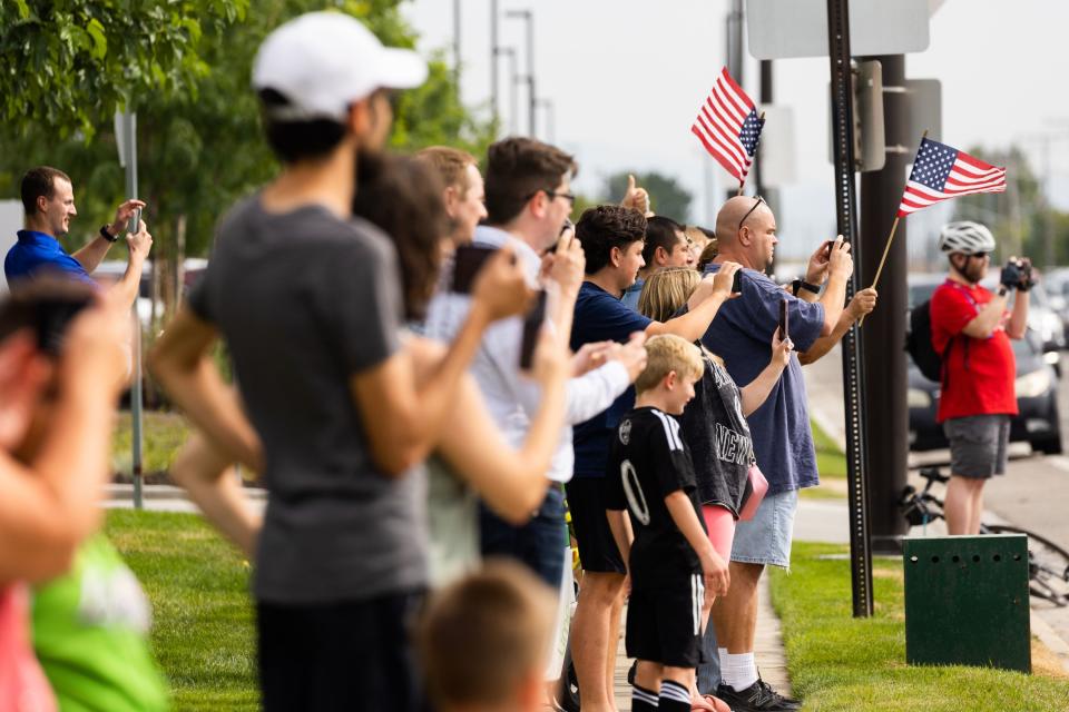 People gather to watch the presidential motorcade drive out of the Roland R. Wright Air National Guard Base in Salt Lake City on Wednesday, Aug. 9, 2023. | Megan Nielsen, Deseret News