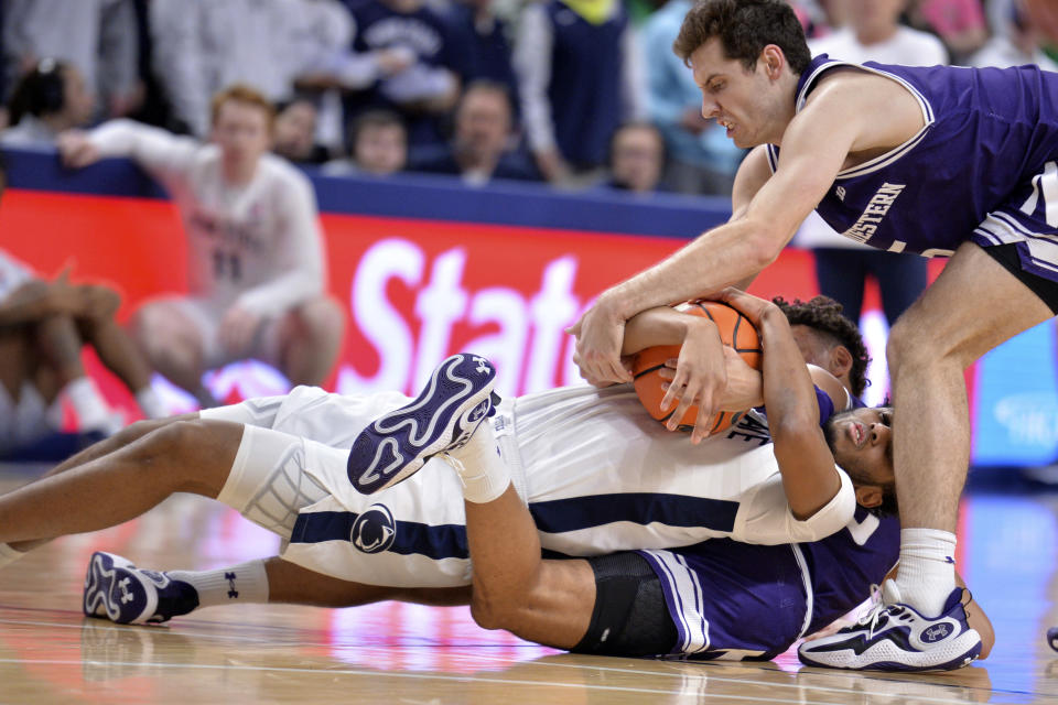 Penn State's D'Marco Dunn (2) attempts to keep possession of the ball from Northwestern's Ryan Langborg, standing, during the first half of an NCAA college basketball game Wednesday, Jan. 10, 2024, in State College, Pa. (AP Photo/Gary M. Baranec)