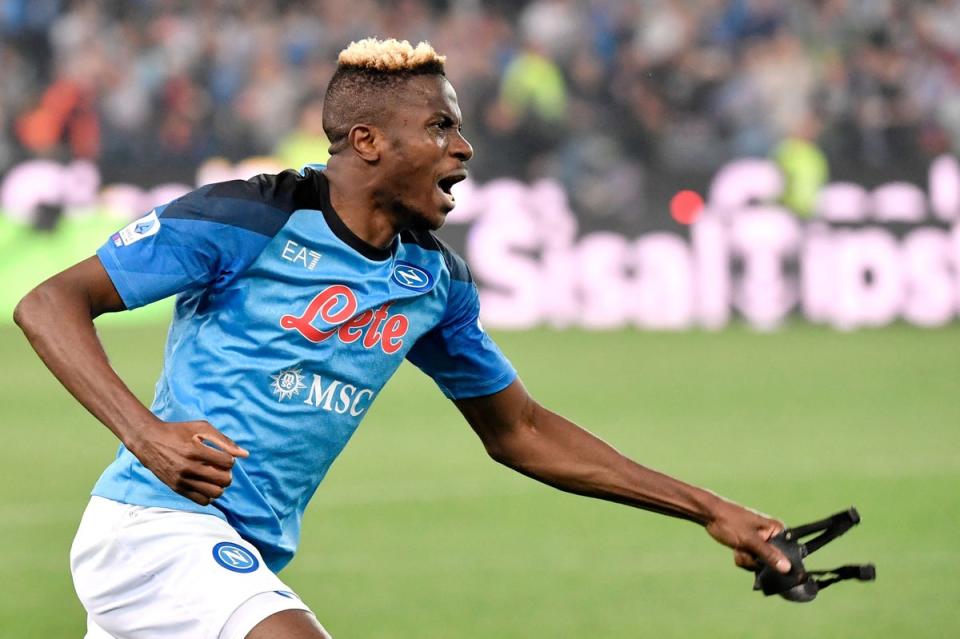 Napoli's Nigerian forward Victor Osimhen celebrates Napoli winning the Scudetto title after the referee blew the final whistle of the Italian Serie A football match between Udinese and Napoli (AFP via Getty Images)