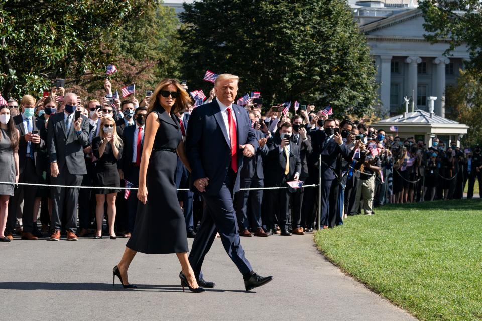 President Donald Trump gives thumbs up, accompanied by first lady Melania Trump, as they walk to board Marine One on the South Lawn of the White House on Oct. 22, 2020, in Washington. Trump is headed to Nashville, Tennessee, for a debate.