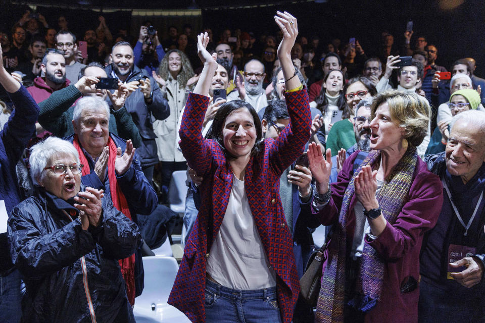 Elly Schlein, center, gestures at the headquarters of her electoral committee, after the announcement of the partial results of the Democratic Party primaries in Rome, Italy, Sunday, Feb. 26, 2023. Schlein, a 37-year-old U.S.-Italian national and longtime left-wing political operative, has defied polls to become the first woman to head Italy’s opposition Democratic Party. (Roberto Monaldo/LaPresse via AP)