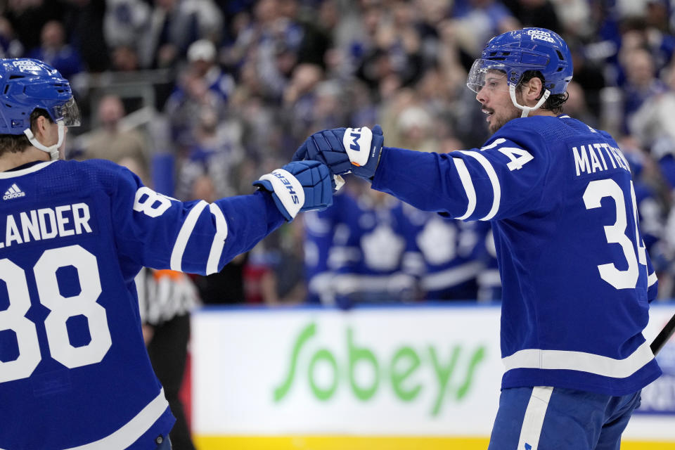 Toronto Maple Leafs center Auston Matthews (34) celebrates with teammate William Nylander (88) after Matthews scored against the Detroit Red Wings during the second period of an NHL hockey game Saturday, April 13, 2024, in Toronto. (Frank Gunn/The Canadian Press via AP)