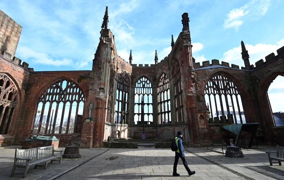 A man walks through the ruins of the 14th century Gothic Coventry Cathedral in Coventry, central England, on February 12, 2020 which was bombed by the German Luftwaffe during World War II. - One place that understands only too well the devastation wreaked on Dresden during World War II is Coventry, where memories of a similar raid are etched into the city's consciousness. Hundreds of Luftwaffe bombers rained fire on the central English city on the night of November 14, 1940, targeting its aircraft and munitions that were vital to Britain's war effort. The new cathedral, also called St Michael's, was consecrated on May 25, 1962 next its 14th century predecessor that was bombed on November 14, 1940 during the Second World War. (Photo by Paul ELLIS / AFP) / TO GO WITH AFP STORY BY Paul ELLIS (Photo by PAUL ELLIS/AFP via Getty Images)