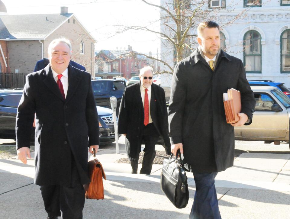 The defense team for Jeff Thomas, Eric Jackson Lurie (left) and Ryan Tutera (right), both of Pittsburgh, enter the Somerset County Courthouse during his trial.