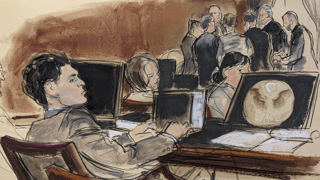 In this courtroom sketch, FTX founder Sam Bankman-Fried, foreground, sits at the defense table while Judge Lewis Kaplan and attorneys discuss final jury selection in his trial, Wednesday, Oct. 4, 2023, in New York. (AP Photo/Elizabeth Williams)