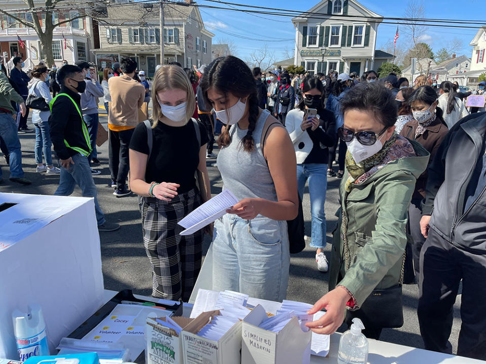 Attendees at an Asian Lives Matter rally in Basking Ridge, New Jersey in April pick up multi-language, anti-hate crime pamphlets created by Michaela Wang. (Michaela Wang)