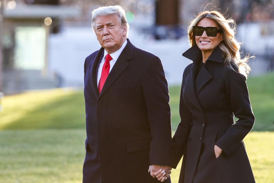 President Donald Trump and first lady Melania Trump walk on the South Lawn of the White House in Washington, DC on December 23, 2020 (Getty Images)