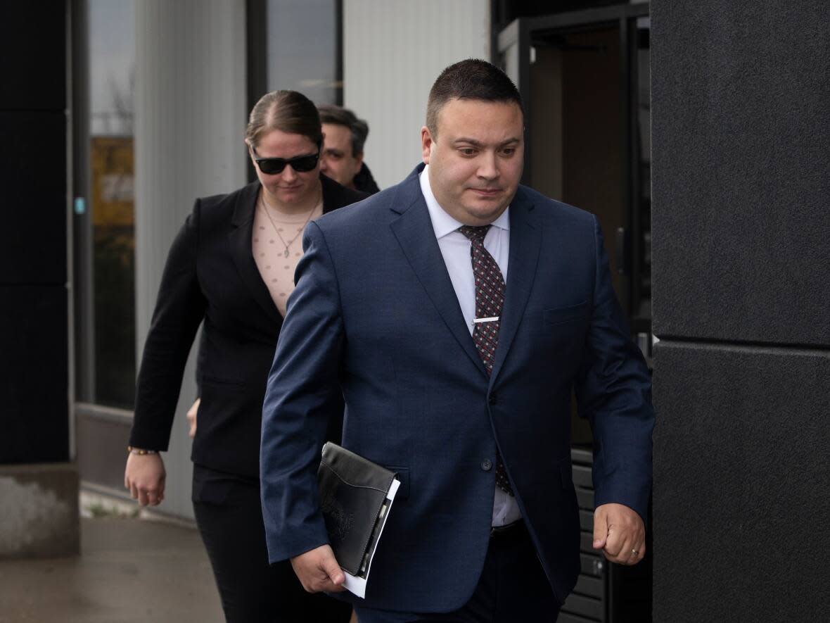 Cpl. Randy Stegner, front, and Const. Jessica Brown leave court after another day of their jury trial on charges of manslaughter and aggravated assault on Friday, November 25, 2022.  (Amber Bracken/The Canadian Press - image credit)