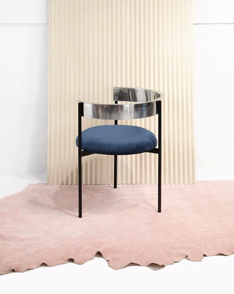 A steel back rest flows seamlessly down into a plush velvet cushion on the thoughtfully designed ARO chair by Ries.