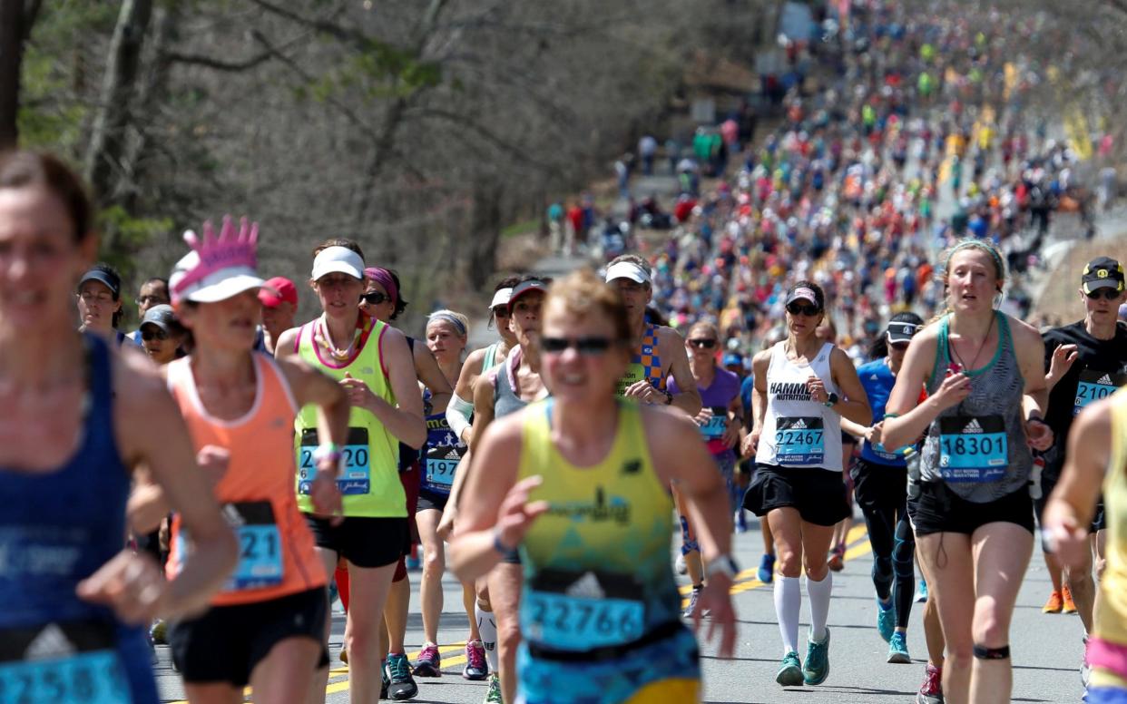 Runners jog up the hills leading to Wellesley College during the 121st running of the Boston Marathon - REUTERS