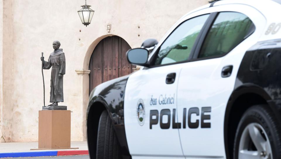 A police vehicle parks near a statue of Junipero Serra in front of the San Gabriel Mission in San Gabriel, California, on Sunday. (Photo: FREDERIC J. BROWN via Getty Images)