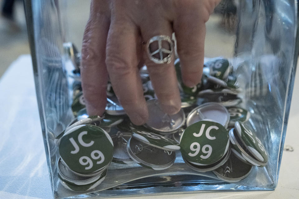 A person grabs a free pin during a celebration for President Jimmy Carter's 99th birthday held at The Carter Center in Atlanta on Saturday, Sept. 30, 2023. (AP Photo/Ben Gray)