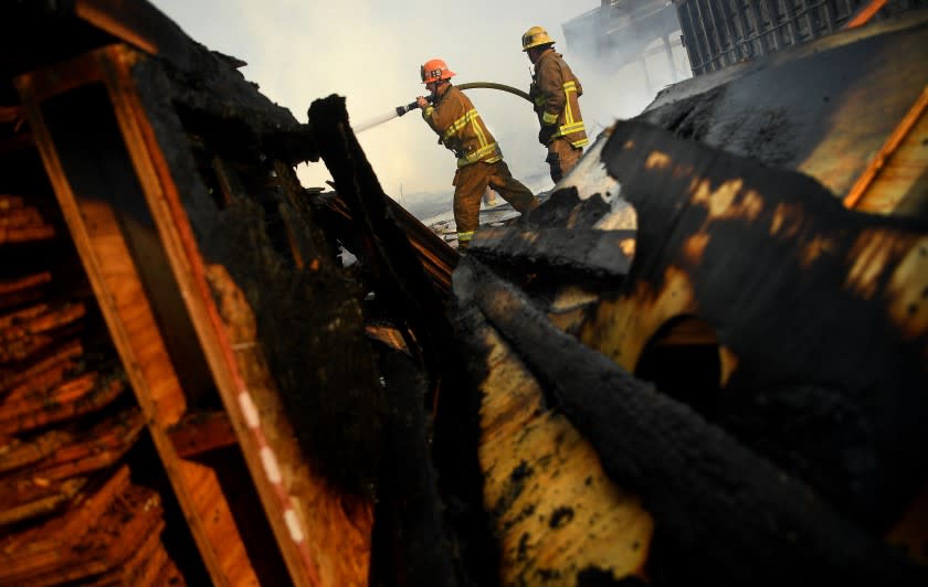 COMPTON, CALIFORNIA FEBRUARY 26, 2021-Firefighters battle an industrial fire in Compton Friday morning. Multiple structers, vehicles and wooden pallets were burned. (Wally Skalij/Los Angeles Times)