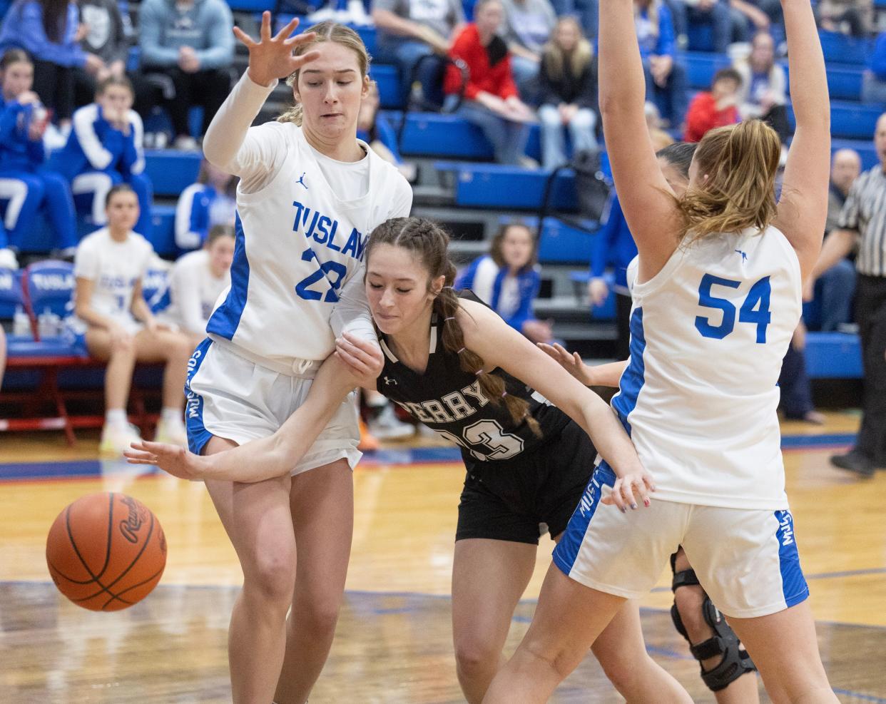 Perry's Breanna Haynes, splits the defense of Tulsaw's Destiny Dulkoski (22) and Breanna McCabe (54) in the first half of Wednesday's game.