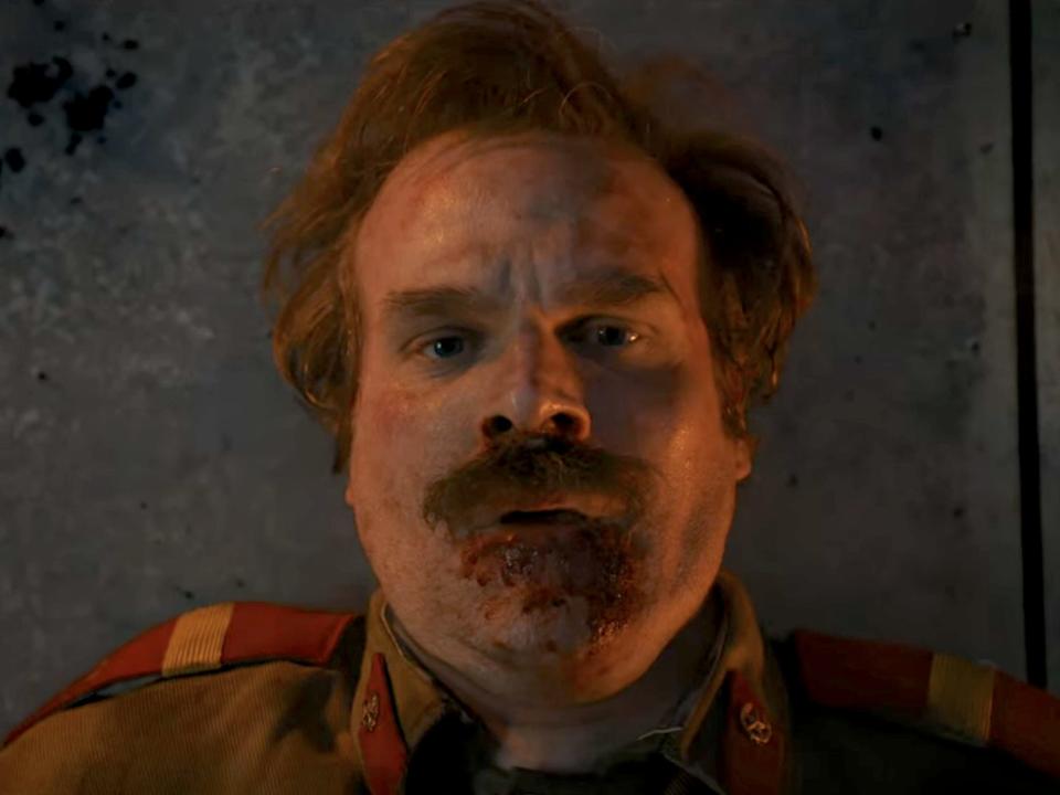 A close up of a man with brown hair and mustache Hopper (played by David Harbour) in "Stranger Things."