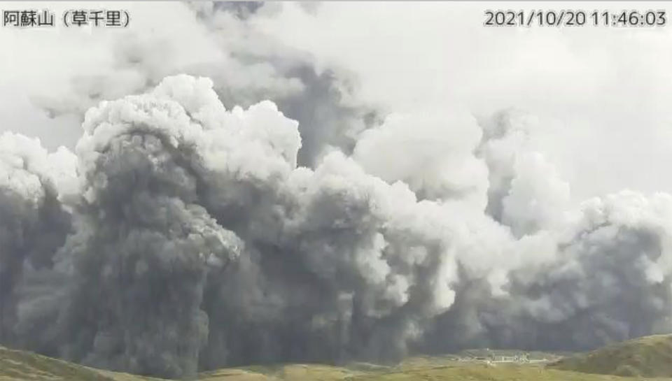 In this image taken by a surveillance camera released by Japan Meteorological Agency, smokes rise from the No. 1 Nakadake crater of Mr. Aso after its eruption, observed from Kusasenri, southwestern Japan, Wednesday, Oct. 20, 2021. The eruption occurred at 11:43 a.m., according to the agency. (Japan Meteorological Agency via AP)