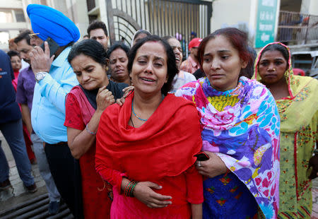 Family members cry after seeing the body of their relative after a commuter train traveling at high speed ran through a crowd of people on the railway tracks on Friday, outside a hospital in Amritsar, India, October 20, 2018. REUTERS/Adnan Abidi