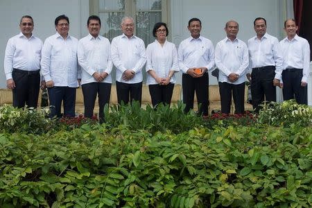 Indonesia's new ministers, (L-R) Transmigration Minister Eko Putro Sandjojo, Industry Minister Airlangga Hartarto, Administrative and Bureaucratic Reform Minister Asman Abnur, Trade Minister Enggartiasto Lukita, Finance Minister Sri Mulyani Indrawati, Coordinating Minister for Legal, Security and Politics Wiranto, Education Minister Muhadjir Effendy, Transportation Minister Budi Karya Sumadi, and Energy and Mining Minister Archandra Tahar, pose for photographers during the announcement of the new cabinet at Presidential Palace in Jakarta, Indonesia, July 27, 2016. Antara Foto/Widodo S Jusuf/via REUTERS