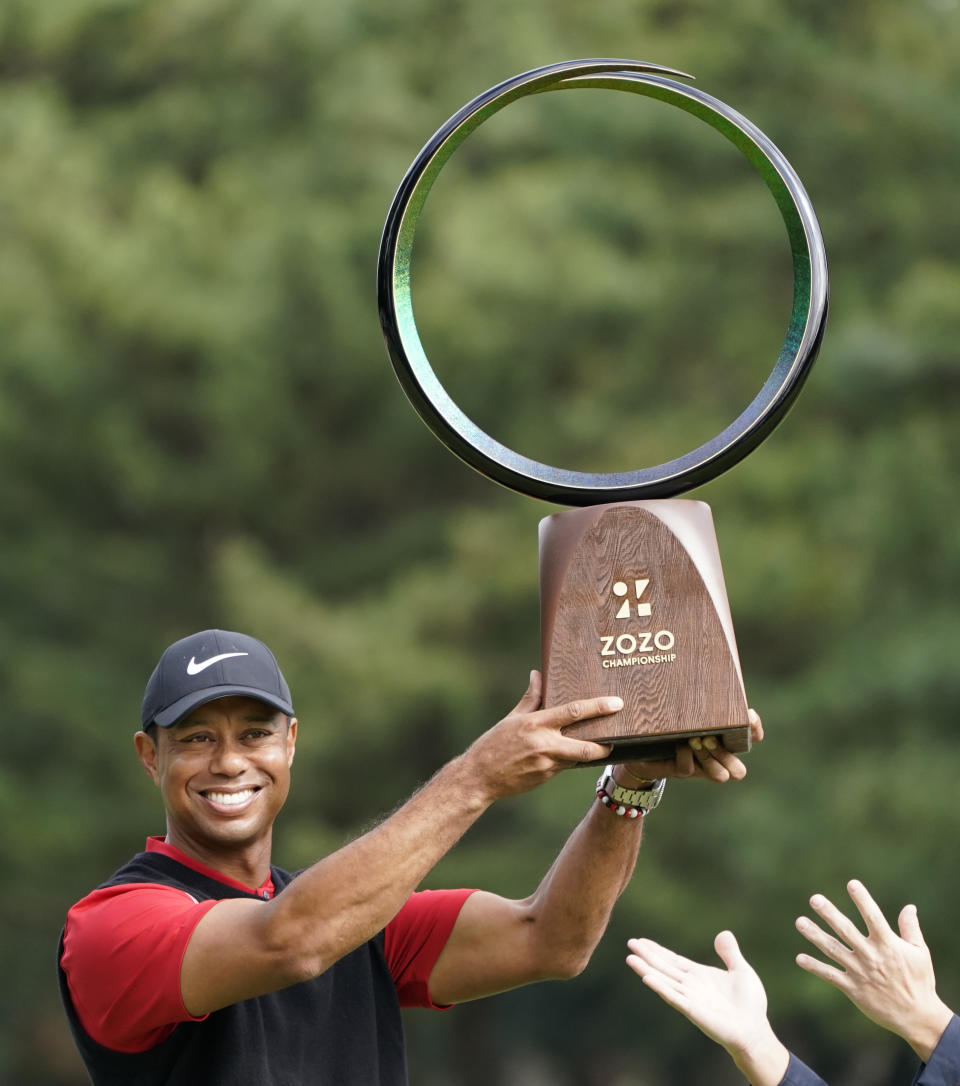 Tiger Woods of the United States poses with his trophy after winning the Zozo Championship PGA Tour at the Accordia Golf Narashino country club in Inzai, east of Tokyo, Japan, Monday, Oct. 28, 2019. (AP Photo/Lee Jin-man)