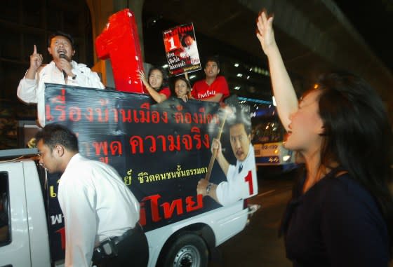 A woman shows her support for candidate Chuwit Kamolvisit as he campaigns through Bangkok’s tourist-friendly red-light district of Patpong, on Feb. 4, 2005. <span class="copyright">Frederic J. Brown—AFP/Getty Images</span>