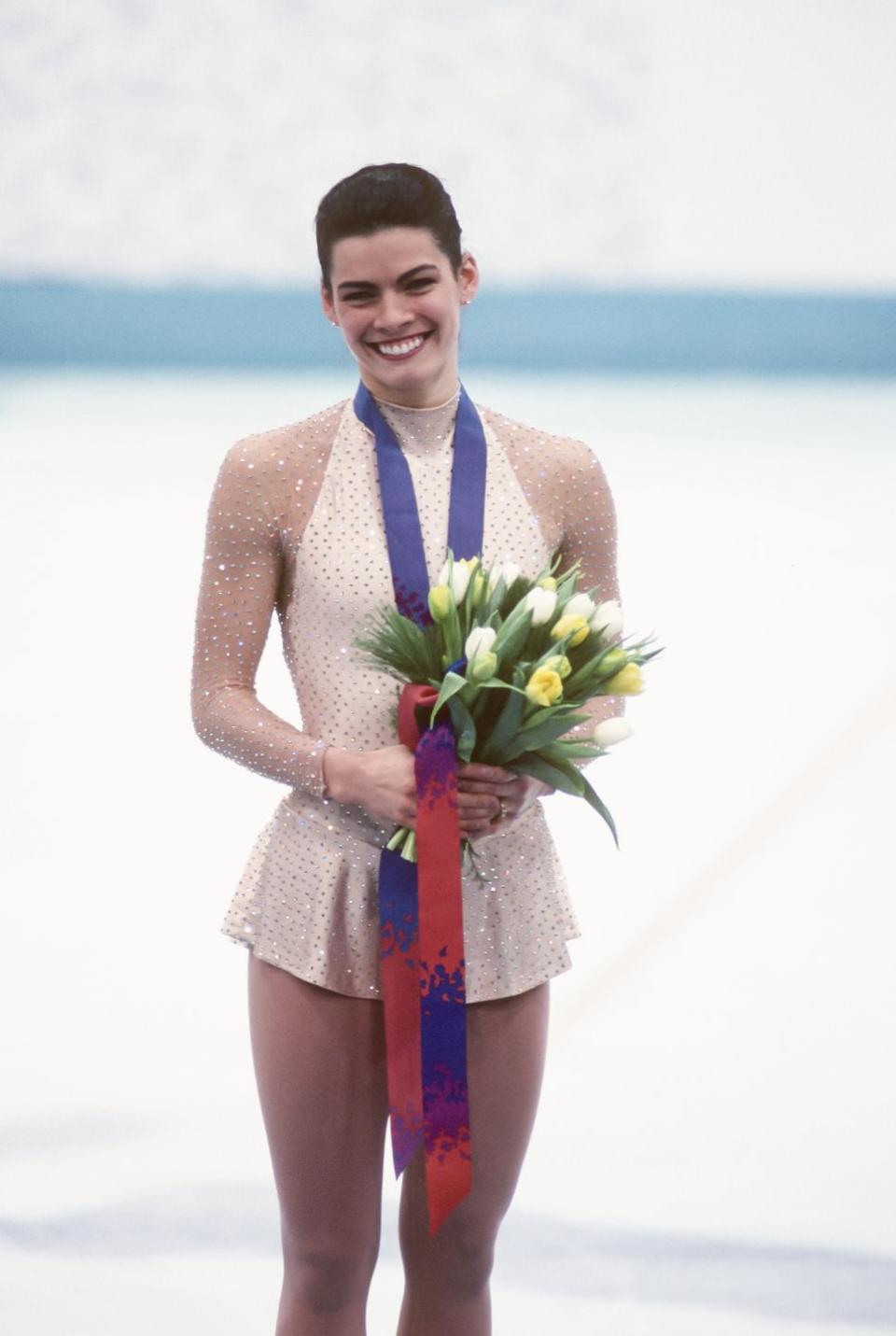 <p>In 1992, Nancy Kerrigan won her first major title at the U.S. Nationals, qualifying her for the Olympic team. She won bronze and would medal again in 1994—but not without major hardship. At the ’94 U.S. Nationals, Nancy was attacked with a metal baton. It was later found that the then-husband of her biggest rival, Tonya Harding, <a href="https://olympics.com/en/athletes/nancy-kerrigan" rel="nofollow noopener" target="_blank" data-ylk="slk:orchestrated the crime;elm:context_link;itc:0;sec:content-canvas" class="link ">orchestrated the crime</a>. The U.S. figure skating authorities held a spot open for Nancy anyway, should she recover—and she did. Nancy overcame the odds and won silver at the 1994 Olympics.</p>