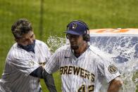 Milwaukee Brewers' Luis Urias dunks Eric Sogard after Sogard hit a walk off two-run home run during the ninth inning of a baseball game against the Pittsburgh Pirates Saturday, Aug. 29, 2020, in Milwaukee. The Brewers won 7-6. (AP Photo/Morry Gash)