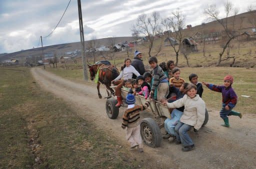 Romanian children, members of the Roma community, ride on a horse pulled cart back to their homes in Hetea village, 200 kms north of Bucharest, in March 2012. In this deprived village of central Romania, the number of children enrolled at the kindergarten went from 89 two years ago to 174 today thanks to a program developed by NGO Ovidiu Rom in partnership with the local community