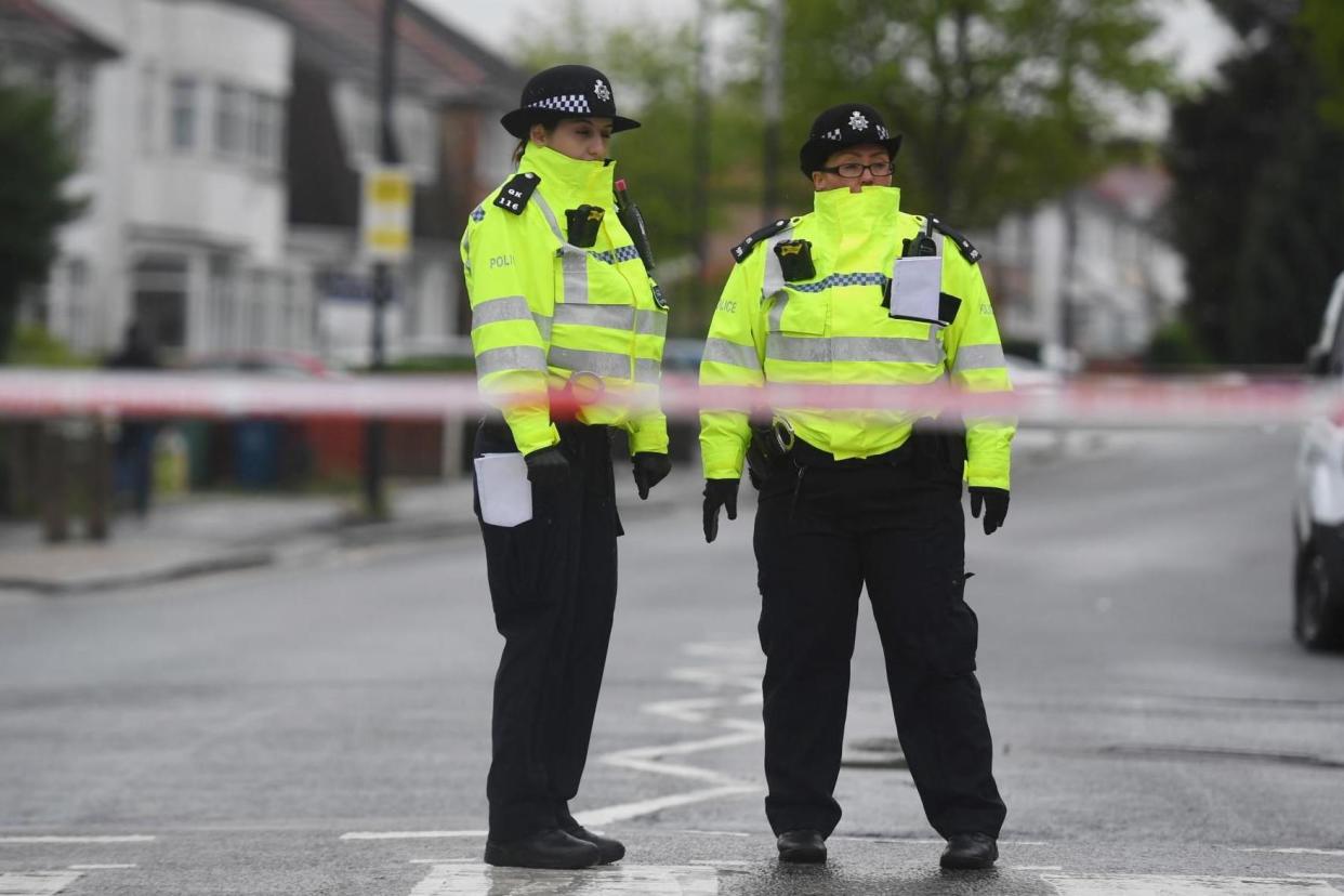 <p>Police officers stand at a cordon </p> (PA Archive/PA Images)