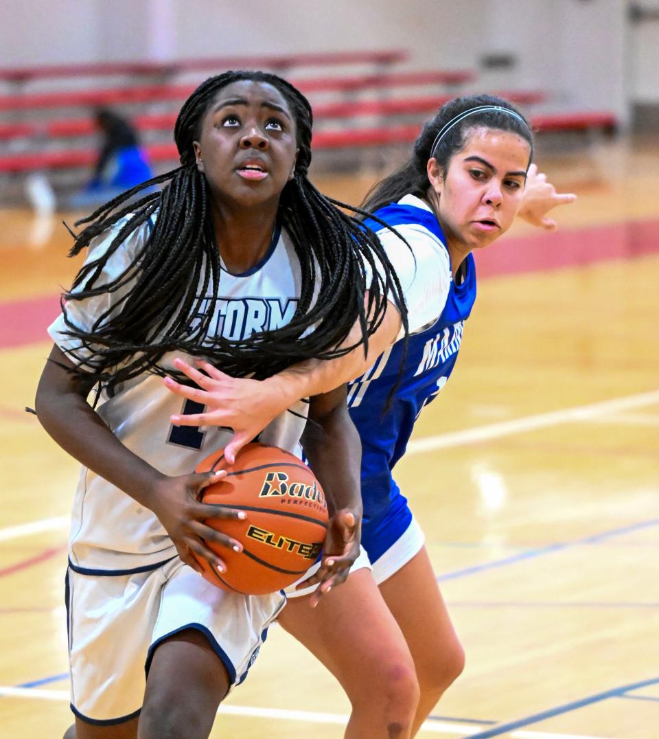 Nina McKim-Right of Falmouth Academy reaches in on Noriann Wray of Sturgis East.