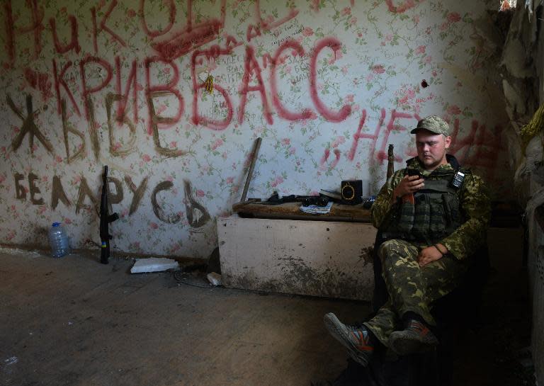 A Ukrainian serviceman rests while manning a position on the frontline of fighting against pro-Russian separatists near Donetsk in eastern Ukraine, May 29, 2015