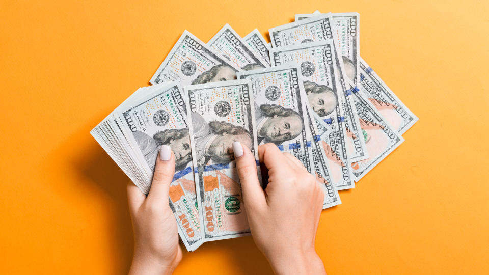 Top view of female hands counting money.