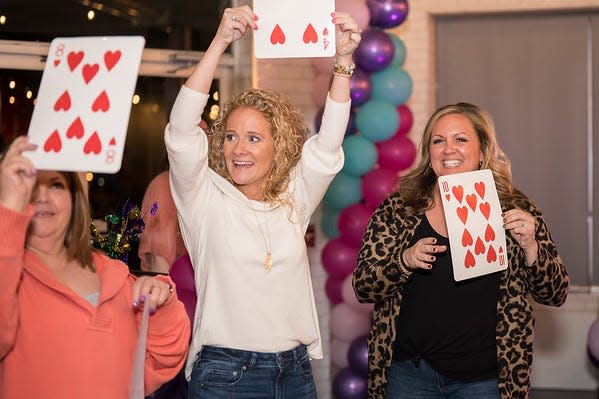 Alivia Hershberger (center) founding director of Simply Give, leads a game at the charity's 2023 "Mardi Bra" fundraiser to benefit women and girls in need. This year, Simply Give hopes to collecting 10,000 items to celebrate its10th anniversary