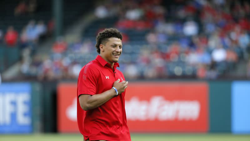 Patrick Mahomes smiles after throwing out the ceremonial first pitch before a baseball game between the Toronto Blue Jays and Texas Rangers on Friday, May 13, 2016, in Arlington, Texas.