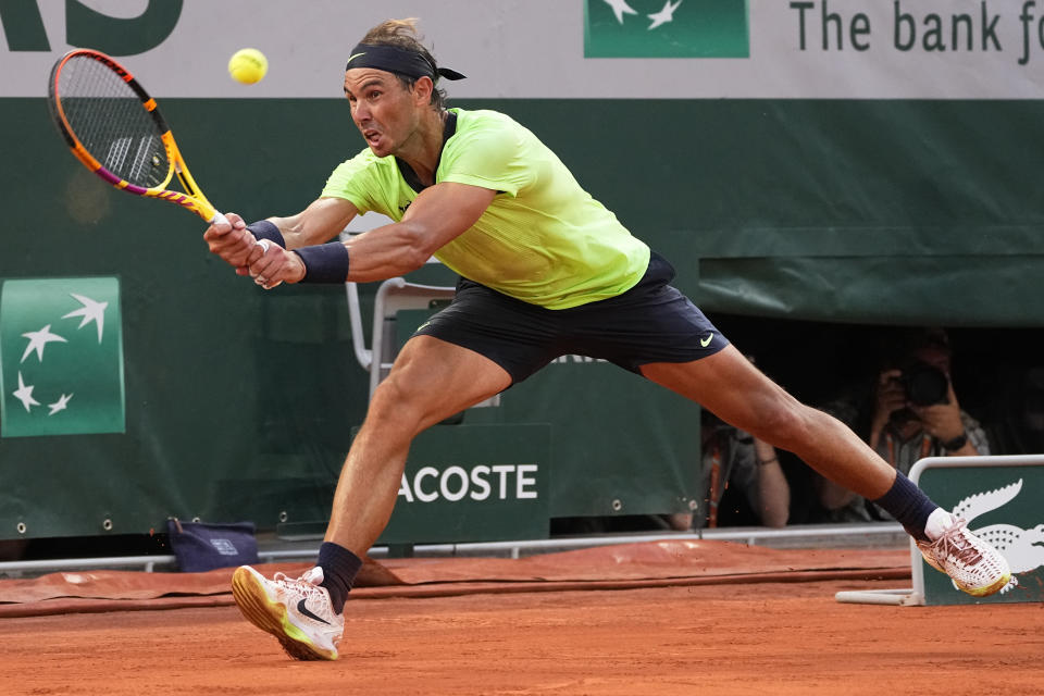 Spain's Rafael Nadal reaches the ball as he plays Serbia's Novak Djokovic rduring their semifinal match of the French Open tennis tournament at the Roland Garros stadium Friday, June 11, 2021 in Paris. (AP Photo/Michel Euler)
