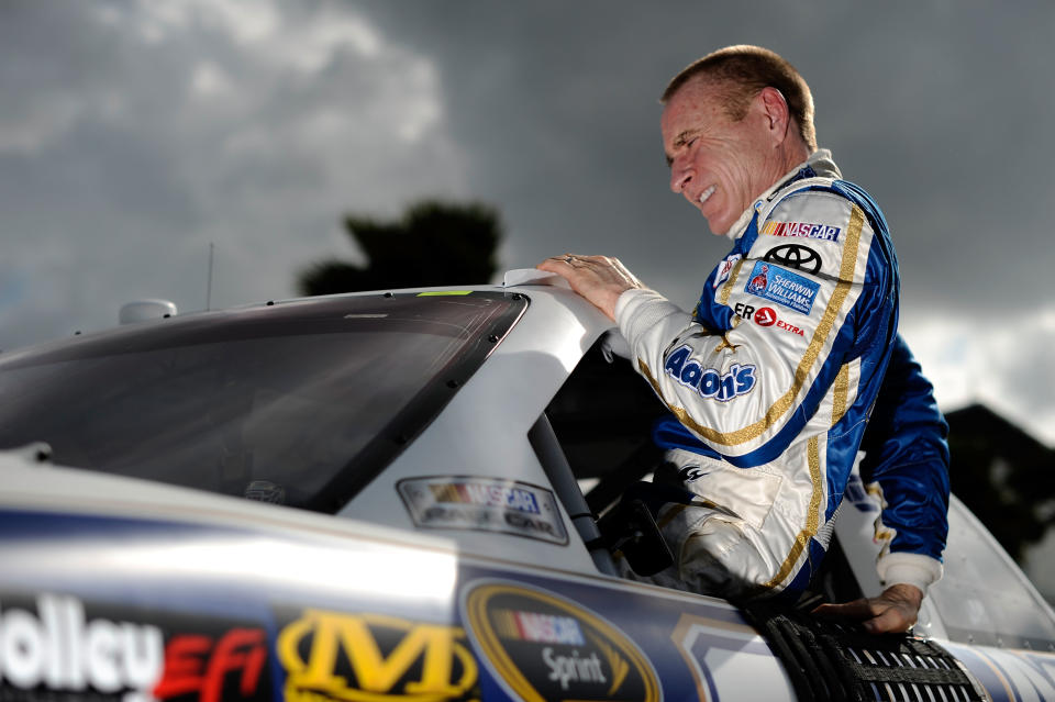 DAYTONA BEACH, FL - FEBRUARY 19: Mark Martin, driver of the #55 Aaron's Toyota, climbs from his car after qualifying for the NASCAR Sprint Cup Series Daytona 500 at Daytona International Speedway on February 19, 2012 in Daytona Beach, Florida. (Photo by Jared C. Tilton/Getty Images for NASCAR)