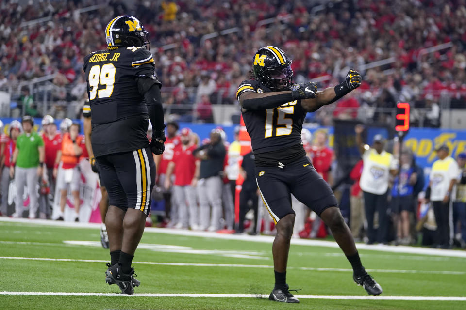 Missouri defensive lineman Johnny Walker Jr. (15) celebrates with defensive lineman Realus George Jr. (99) after a sack against Ohio State during the first half of the Cotton Bowl NCAA college football game Friday, Dec. 29, 2023, in Arlington, Texas. (AP Photo/Julio Cortez)