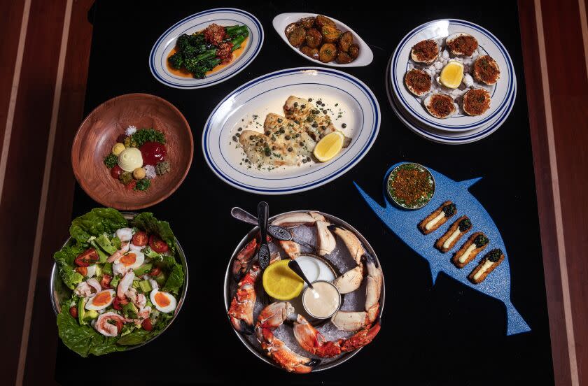 MARINA DEL REY, CA-JANUARY 4, 2023: Clockwise from bottom left-Shrimp Louis, Sand dabs with sides of broccolini and lemony potatoes, Clams Casino, Bougie fish sticks, and Stone crab claws are on the menu at Dear Jane's, a seafood focused restaurant in Marina del Rey. (Mel Melcon / Los Angeles Times)