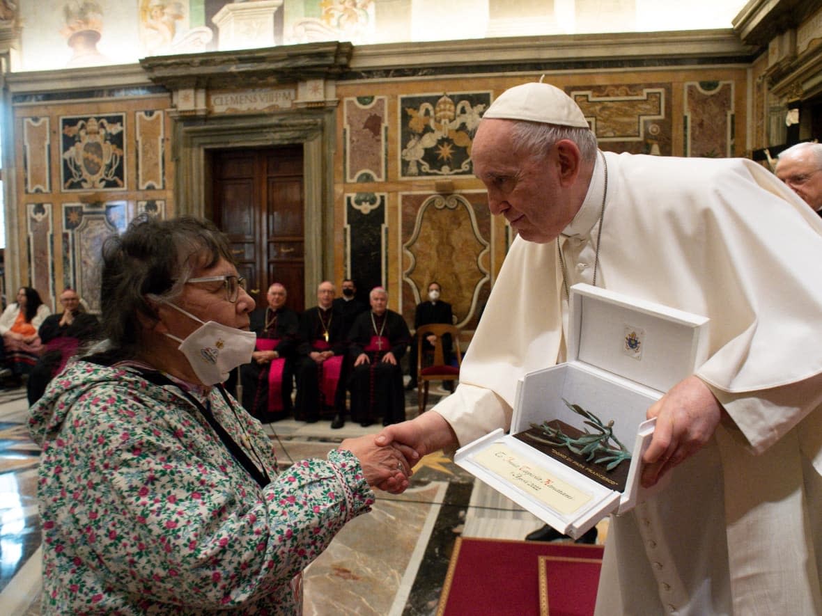 Pope Francis hands a gift to Rosemary Lundrigan of the Inuit delegation at the Vatican, on Friday, April 1, 2022. (Vatican Media via Reuters - image credit)