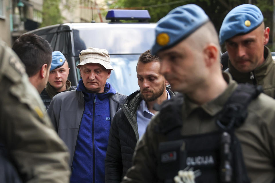 Members of the special police unit of Canton Sarajevo escort Vahidin Munjic, chief of the Federal Police, during an operation codenamed "Black Tie" in Sarajevo, Bosnia, Monday, April 22, 2024.In a large-scale raid conducted in Bosnia and Herzegovina, law enforcement officers swarmed homes and offices of 23 persons suspected to be part of the 'inner circle' of a drug kingpin. (AP Photo/Armin Durgut)