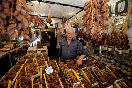 Djamel Bouktech, 66, a dates seller poses for a photograph at his shop in the old city of Algiers, Algeria, May 17, 2017. REUTERS/ Ramzi Boudina