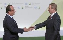 French President Francois Hollande (L) welcomes Ireland's Prime Minister Enda Kenny as he arrives for the opening day of the World Climate Change Conference 2015 (COP21) at Le Bourget, near Paris, France, November 30, 2015.