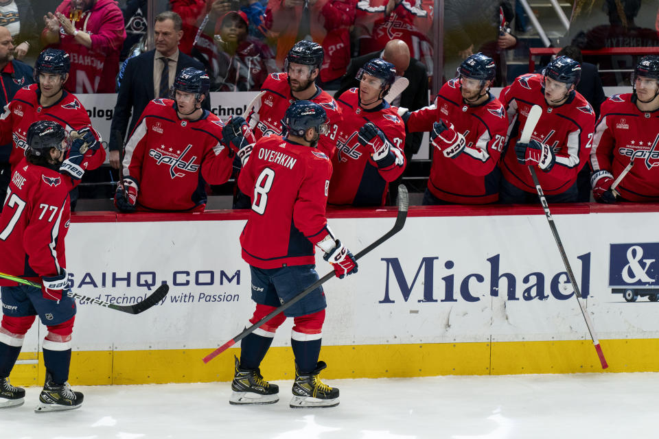 Washington Capitals left wing Alex Ovechkin (8) celebrates with teammates after scoring during the third period of an NHL hockey game against the Colorado Avalanche, Tuesday, Feb. 13, 2024, in Washington. (AP Photo/Stephanie Scarbrough)