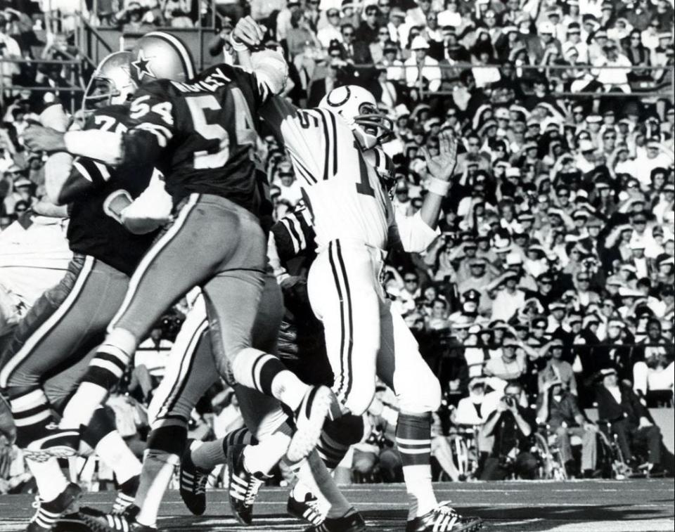 Cowboys linebacker Chuck Howley (54) strips the ball from Colts quarterback Earl Morrall in Super Bowl V.