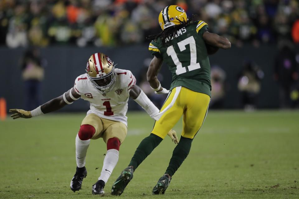 Green Bay Packers' Davante Adams tries to get past San Francisco 49ers' Jimmie Ward during the first half of an NFC divisional playoff NFL football game Saturday, Jan. 22, 2022, in Green Bay, Wis. (AP Photo/Aaron Gash)