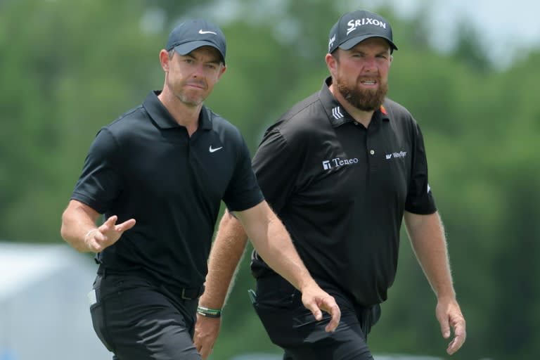 Rory McIlroy of Northern Ireland and Shane Lowry of Ireland wave to fans during the second round of the Zurich Classic of New Orleans at TPC Louisiana. (Jonathan Bachman)