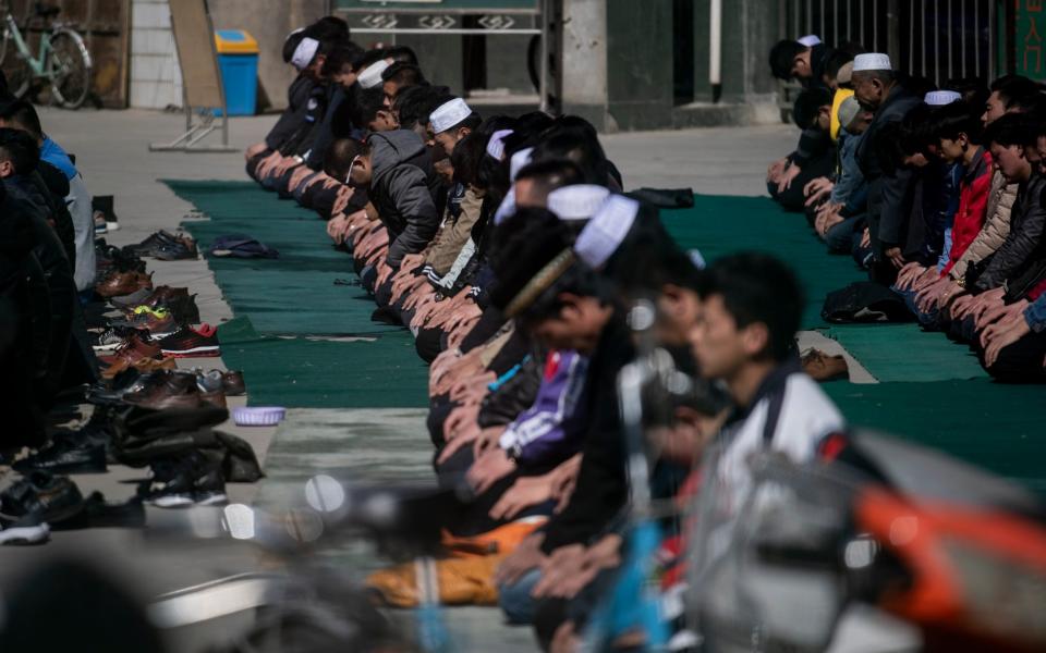 This picture taken on March 2, 2018 shows ethnic Hui Muslim men praying at Nanguan Mosque during Friday prayers in Linxia, China's Gansu province - AFP