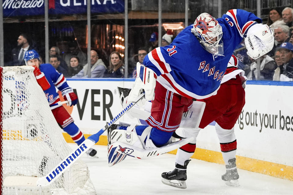 Carolina Hurricanes right wing Andrei Svechnikov (37) trips New York Rangers goaltender Igor Shesterkin (31) during the first period in Game 2 of an NHL hockey Stanley Cup second-round playoff series, Tuesday, May 7, 2024, in New York. (AP Photo/Julia Nikhinson)