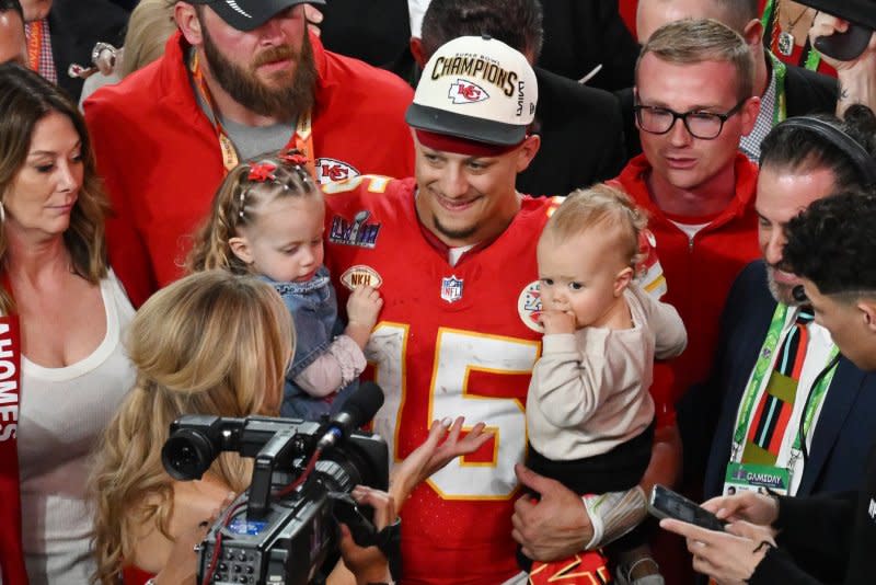 Kansas City Chiefs quarterback Patrick Mahomes holds his children after beating the San Francisco 49ers 25-22 in overtime to win Super Bowl LVIII on Sunday at Allegiant Stadium in Las Vegas. Photo by Jon SooHoo/UPI