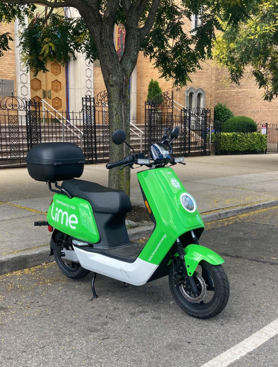 A bright green electric moped from the micromobility company Lime.
